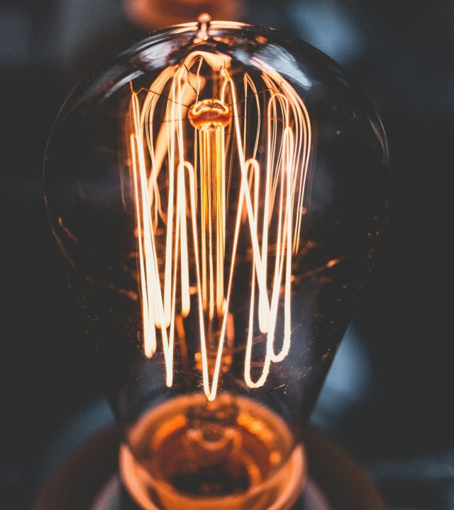 A mesmerizing close-up of a glowing vintage Edison light bulb with warm illumination.